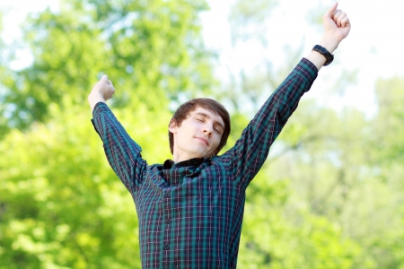 young man Businessman or student having break stretching arms outdoorの写真素材