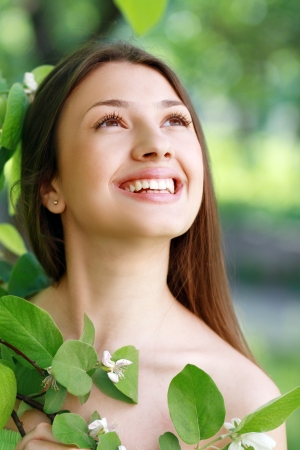 Spring Beauty Girl. Beautiful Young Woman Lying on Green Grass outdoor. Park. Meadow. Summer. Spring Girl on the Field. Happiness. Outdoors. Youth conceptの写真素材