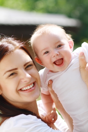 Mother with baby at outdoors in green parkの写真素材
