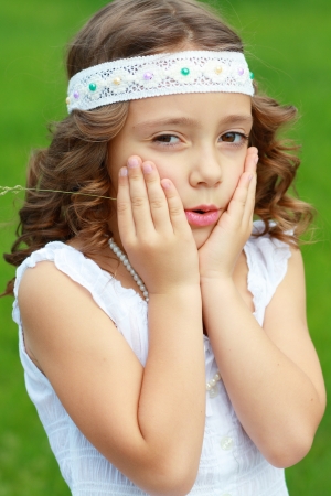 Adorable little girl taken closeup outdoors in summerの写真素材