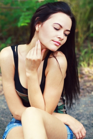 Outdoors closeup portrait of a young tanned brunette beautyの写真素材