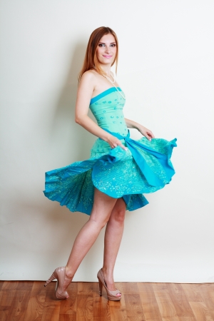 Attractive Young Woman in Bright Blue Dressの写真素材