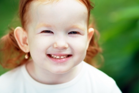Cute little girl on the meadow in summer day の写真素材