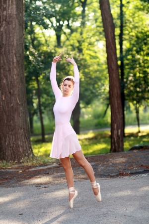 Young beautiful ballerina dancing outdoors in a park. Ballerina Project.の写真素材