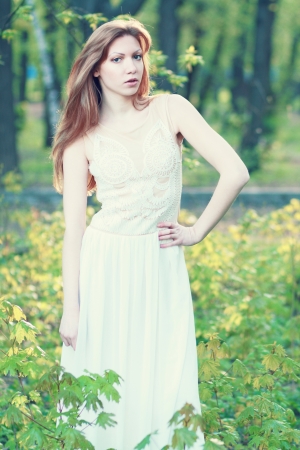 fashion shot of beautiful thoughtful woman in the parkの写真素材