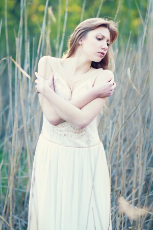 fashion shot of beautiful thoughtful woman in the parkの写真素材