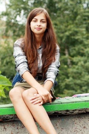 Outdoors street portrait of beautiful young brunette happy smiling teen girlの写真素材