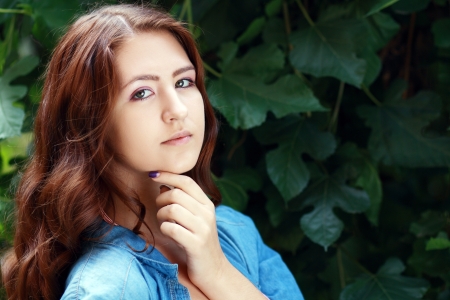 Outdoor portrait of a sad teenage girl looking thoughtful about troublesの写真素材