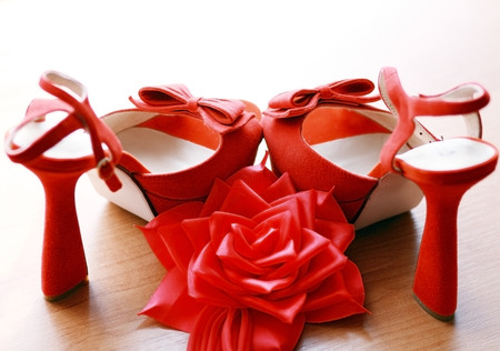 Red women high heel shoes closeup on white background の写真素材