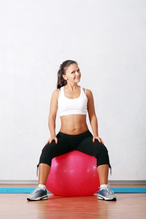 sporty fitness happy woman at the gym with a pilates ballの写真素材