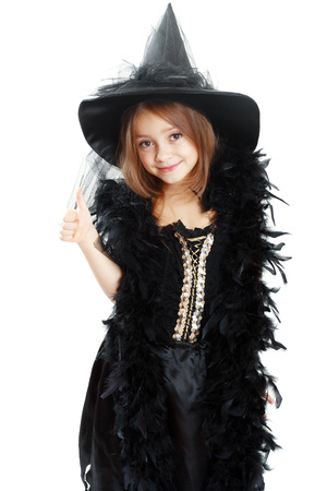 beautiful cute little girl in witch halloween costume show thumb up and smilingの写真素材