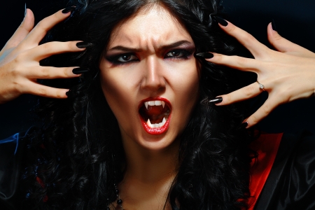 portrait of a woman vampire with fangs on a black backgroundの写真素材