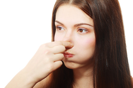 Young Woman Holding her Nose smelling something stinkingの写真素材