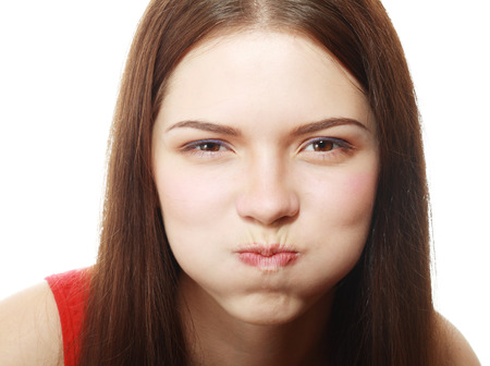 Portrait of disgusted young woman blowing cheeks.White Background,の写真素材