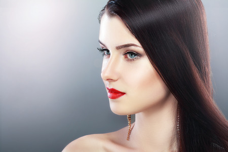 beautiful woman face with perfect make up and red lips profileの写真素材