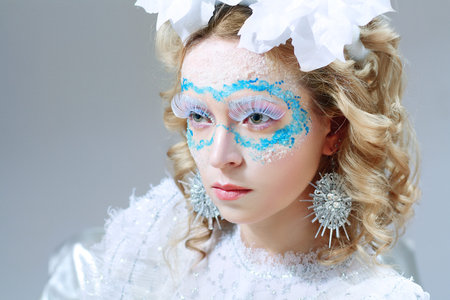 Closeup portrait of beautiful woman with winter style makeup and lantern in hand