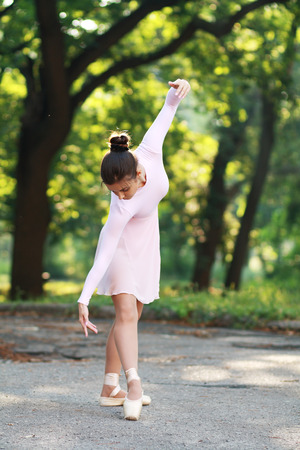 Young beautiful ballerina dancing outdoors in a park. Ballerina Project.の写真素材