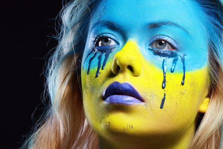 crazy color face art women portrait with yellow and blue as flag of Urkaineの写真素材