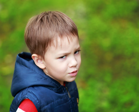 little four years boy outdoor looking unhappy
