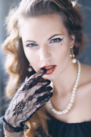 Fashion Brunette Model Portrait. Jewelry and Hairstyle. Elegant lady Isolated on black background.の写真素材