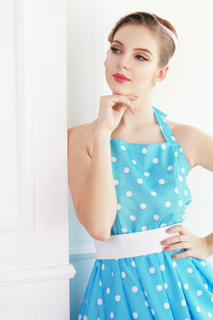 Vintage style fashion portrait of cute smiling blonde teenager girlの写真素材
