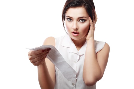 Shopaholic - Attractive brunette woman looking at her receipt - overspendingの写真素材