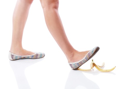 Female leg(foot) and peel of a banana.の写真素材