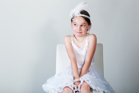 Portrait of cute little girl in luxurious dress and headbundle with feathers. Fashion photoの写真素材