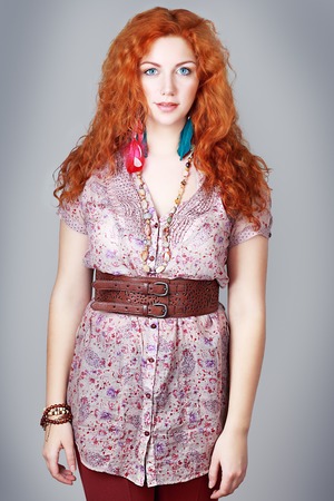 beautiful plus size girl with curly red hair and blue eyesの写真素材