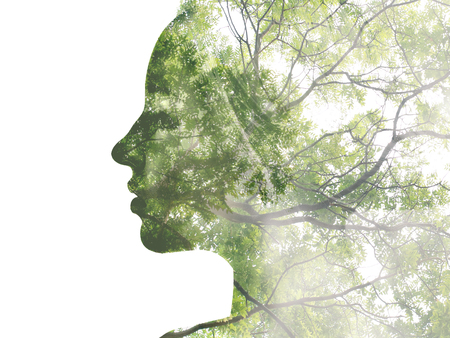 Double exposure portrait of attractive lady combined with photograph of tree. Be creative!