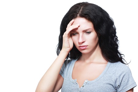 Young businesswoman looking sad against a white backgroundの写真素材