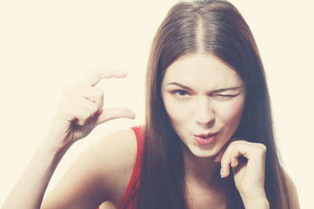 Portrait of girl showing small amount of something retro toningの写真素材