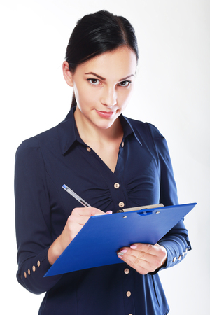 Business woman write on clipboard looking and hearing youの写真素材