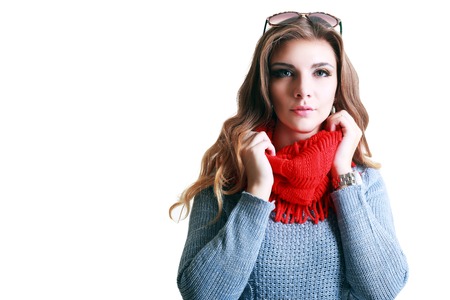 Beautiful woman in sweater is posing in studioの写真素材