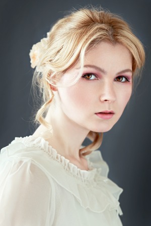 Beautiful girl with flowers in her hair. Romantic style. Spring. Fashion toning.の写真素材