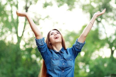 happy woman under a tree in summerの写真素材