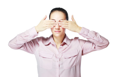 Teen woman covering her eyes isolated on white backgroundの写真素材
