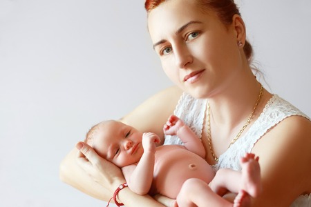 mother holding her newborn daughter close upの写真素材