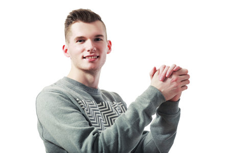 handsome businessman shaking his own hands after making a deal