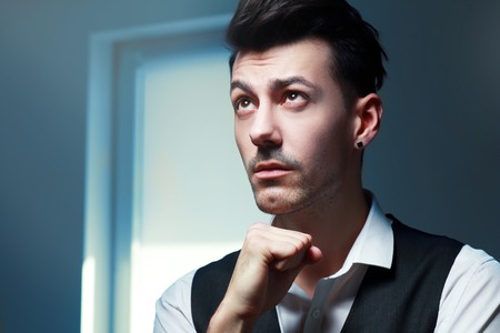 Portrait of thinking young manの写真素材