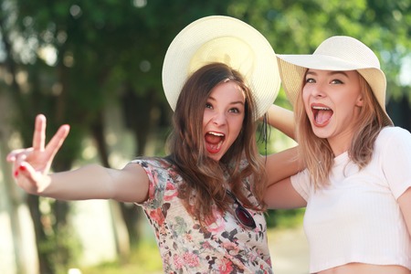 Two young girlfriends in sunglasses having fun. Lifestyle. Summer outdoorの写真素材