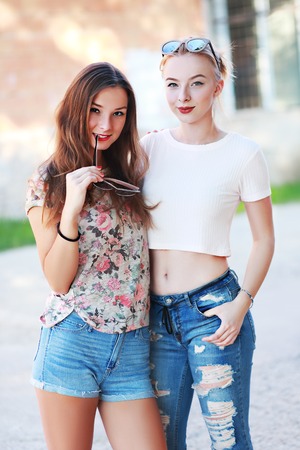 Two young girlfriends in sunglasses having fun. Lifestyle. Summer outdoorの写真素材