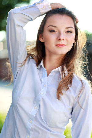 half length portrait of beautiful young confident woman posing on natureの写真素材