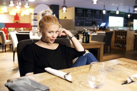 Charming woman in a restaurantの写真素材