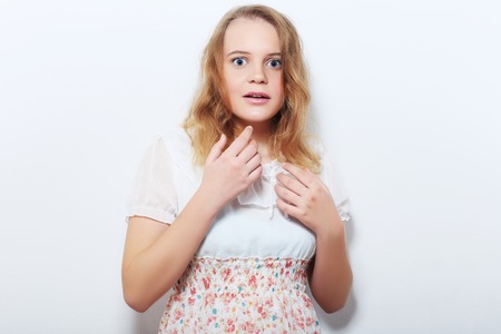 emotions, expressions and people concept - surprised smiling young woman or teenage girlの写真素材