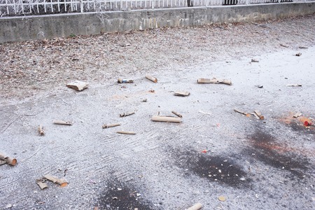 Used fireworks firecrackers lying on snow after exploding in celebration.の写真素材