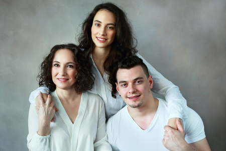 family headshot beautiful woman with grown up daughter and sonの写真素材