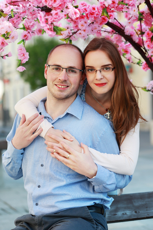 happy couple under blossom spring treeの写真素材