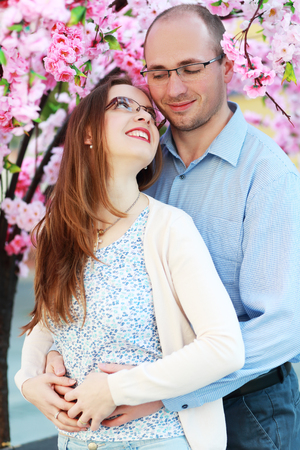happy couple under blossom spring treeの写真素材