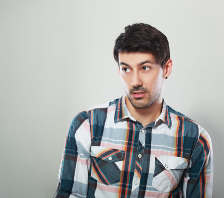 emotional young man disapointed or doubting looking to copyspaceの写真素材